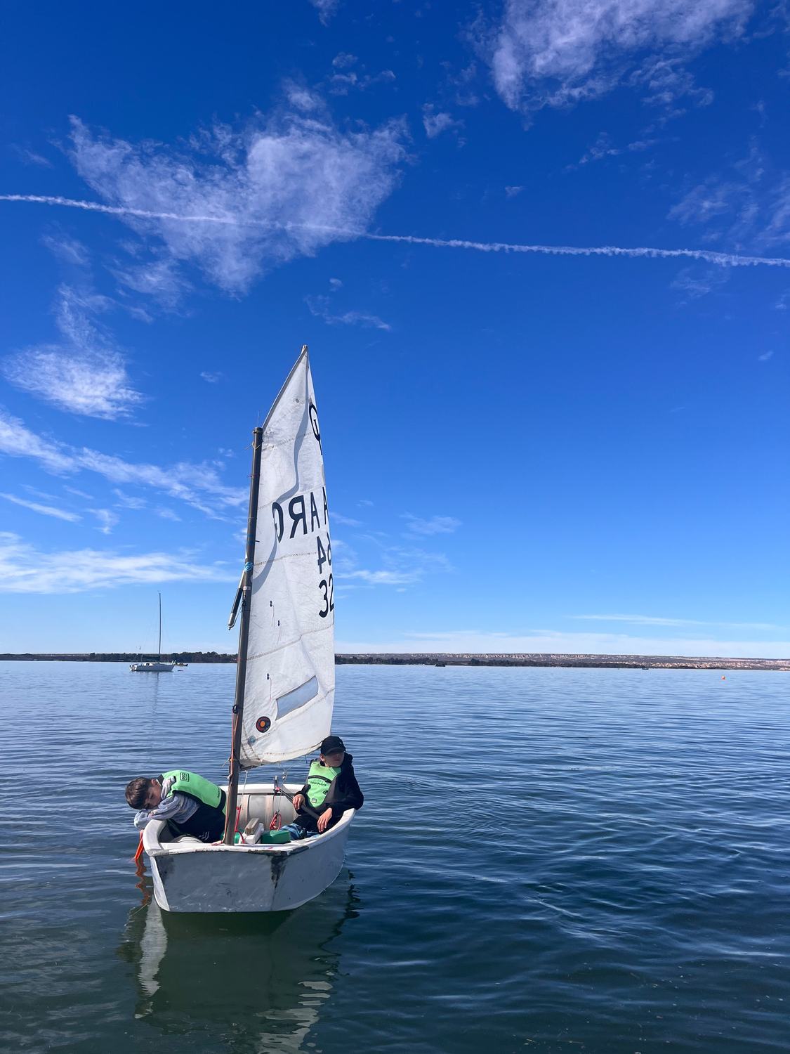 Two kids aboard an Optimist at Potrerillos Reservoir
